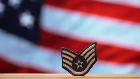 air force military patch with blurred waving american flag background