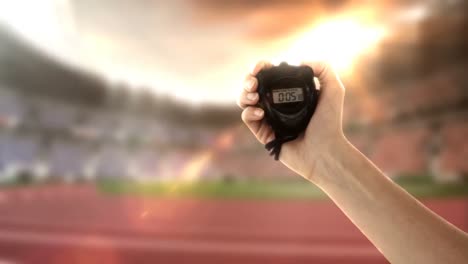 Hand-holding-stopwatch-in-olympic-stadium