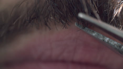 Extreme-macro-shot-of-beard-hair-getting-trimmed-by-clippers