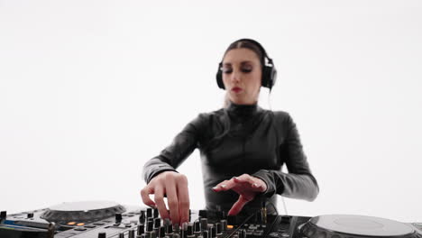 a female dj mixing music on a professional console