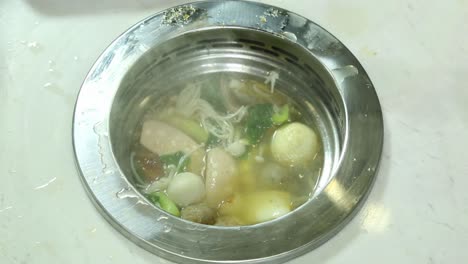 oriental hot pot soup with vegetables and sausages - delicious cuisine - closeup shot