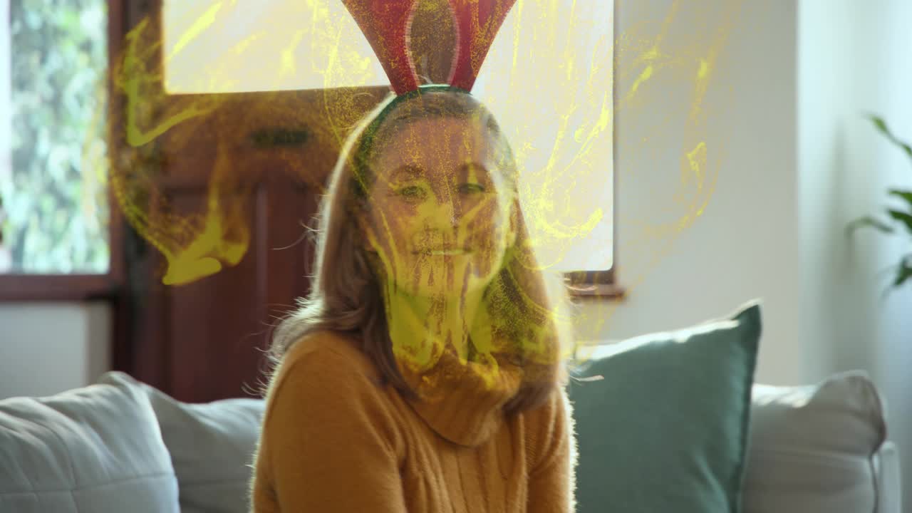 Woman finishing taping holiday gifts, gold effect appearing around hands, placing antler headband