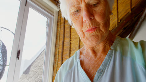 Low-angle-view-of-old-Caucasian-senior-woman-using-smartwatch-4k