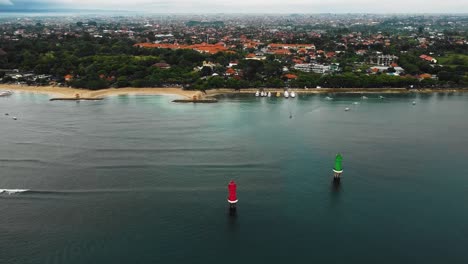 beautiful cinematic sanur beach, bali drone footage with interesting landscape, fishing boats, hotel, resorts and calm weather