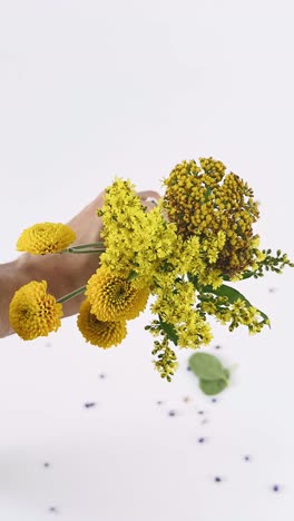 handheld bouquet of yellow flowers