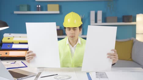 boy future engineer builder architect looking at projects.