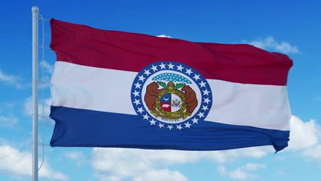 missouri flag on a flagpole waving in the wind, blue sky background. 4k