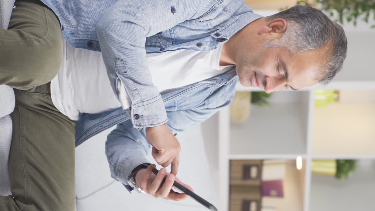 Vertical video of The man is breaking up with his wife on the phone and is upset.