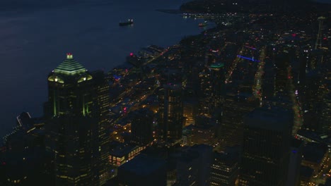 flying above skyscrapers at night dark urban cities establishing shot seattle downtown