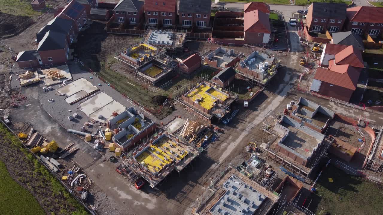 Drone aerial view of house building site in Cheshire, England, UK, Europe, illustrating urban development due to housing shortage in the UK.