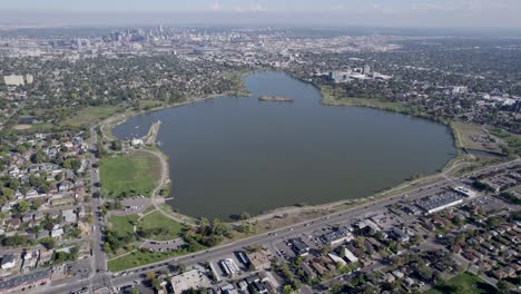 a 4k high-flying drone shot of sloan’s lake, the biggest lake in the city of denver, colorado, and home to the second largest park in the city, and a myriad of outdoor activities