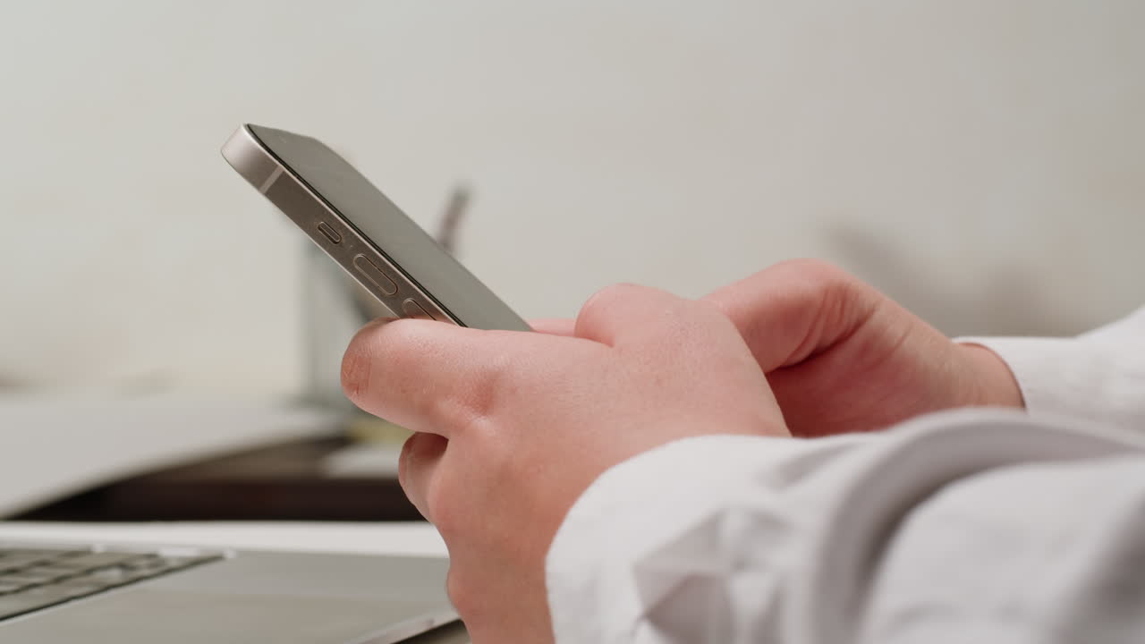 Person using a smartphone in an office setting