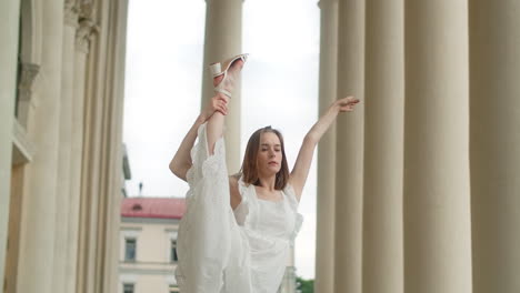 woman in white dress stretching outdoors