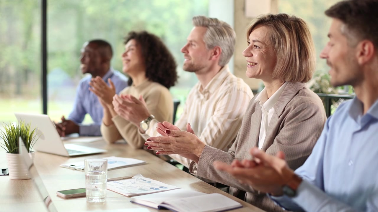 Diverse Business Team Clapping and Smiling During a Meeting