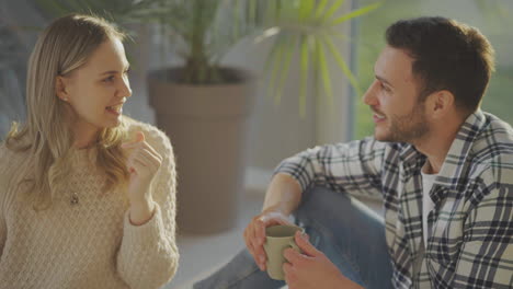 man and woman sitting in new flat