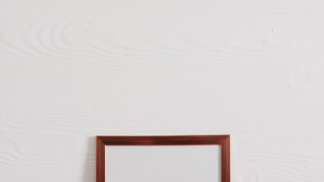 Wooden-frame-with-copy-space-on-white-background-and-white-wall