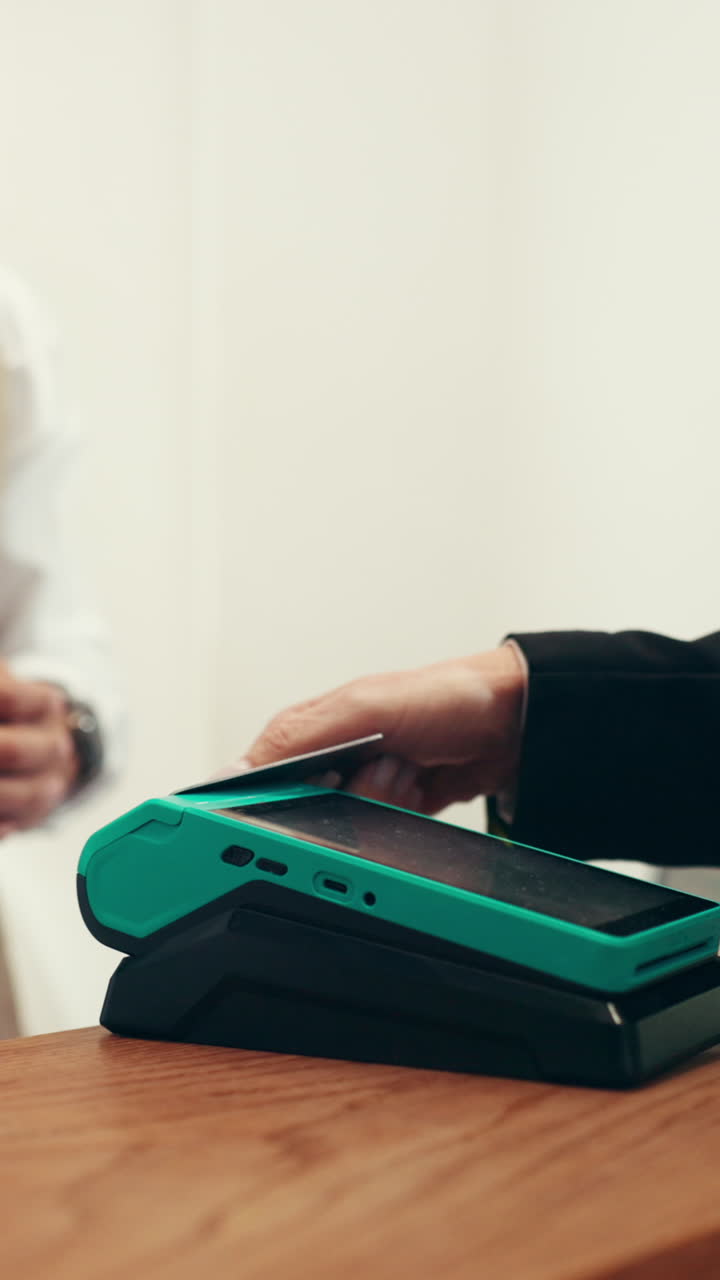 Customer Making Contactless Payment with Credit Card on POS Terminal