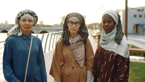 muslim women posing on embankment