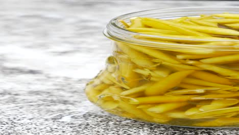 pickled yellow peppers in a glass jar