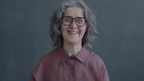 smiling senior woman waving