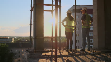 Architektin-Und-Bauarbeiter-Auf-Der-Baustelle,-Rückansicht.-Teamarbeit-Bei-Der-Gebäudeentwicklung-Und-Mitarbeiterkonzept.-Architektin-Und-Bauarbeiter-Auf-Der-Baustelle