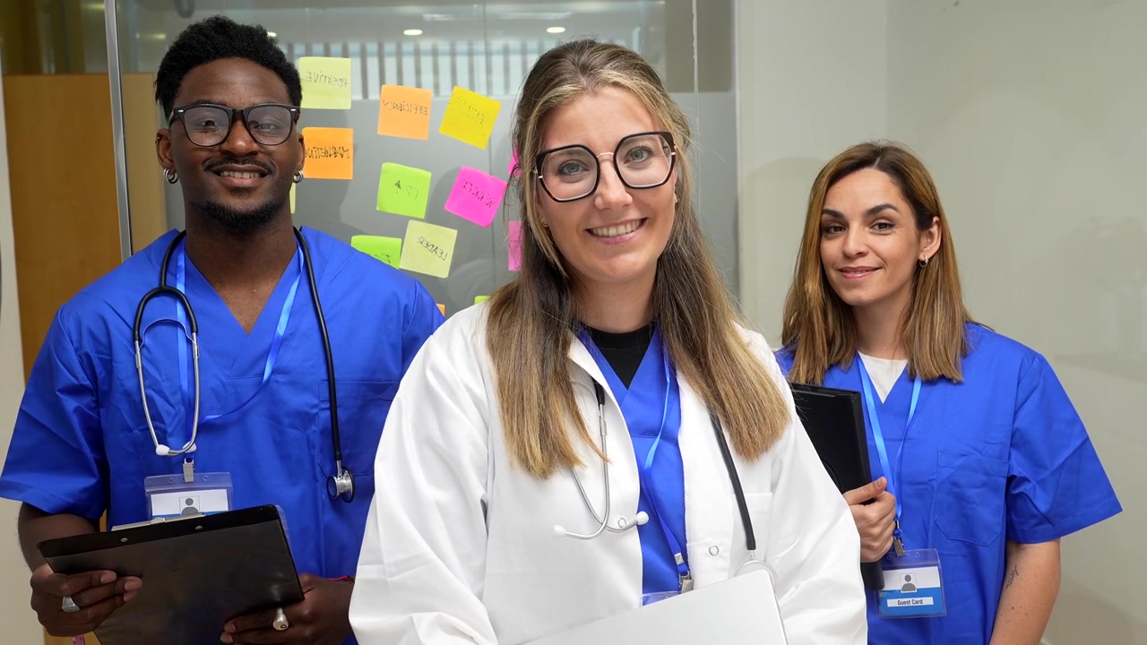 Equipo médico diverso de pie junto en la oficina del hospital