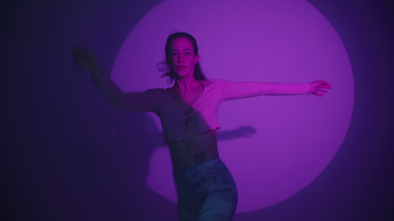 Woman in a Studio Setting with Purple Lighting
