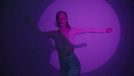 woman in a studio setting with purple lighting