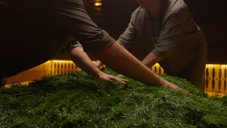 preparing a christmas fir arrangement