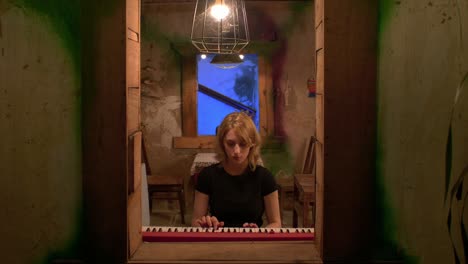 Slow-motion-shot-of-a-woman-playing-and-practicing-on-the-piano-alone-at-home