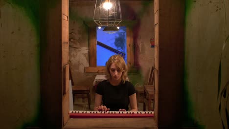 slow motion shot of a woman playing and practicing on the piano alone at home