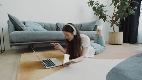 cute young female makes a video call with her laptop at home