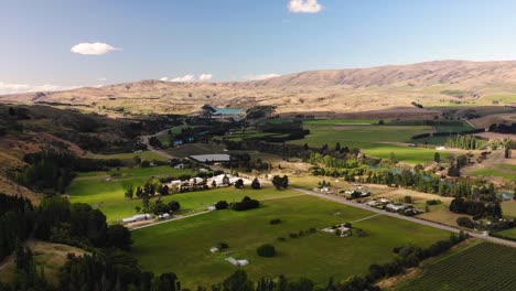 New-Zealand-agriculture-landscape-along-Clutha-River-near-Roxburgh,-aerial-shot