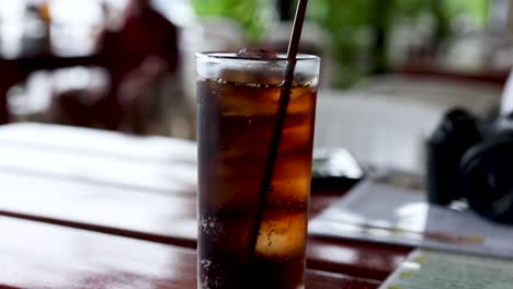 dining scene with cola and camera on table