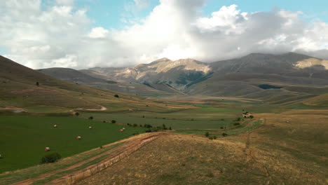 green fields surrounded by valleys at umbria mountains near castelluccio in central italy