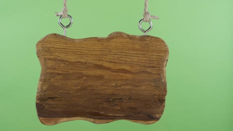 an old empty wooden sign sways to the sides. green screen