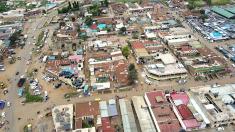 Aerial-view-of-cars-and-people-at-a-Open-Air-Market,-in-Africa---reverse,-drone-shot