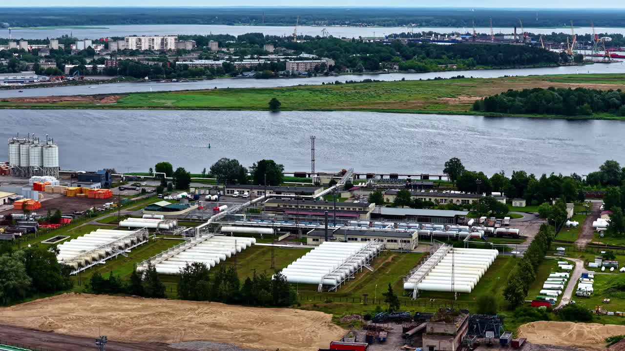 Aerial shot of an industry situated beside a river. Industrialization