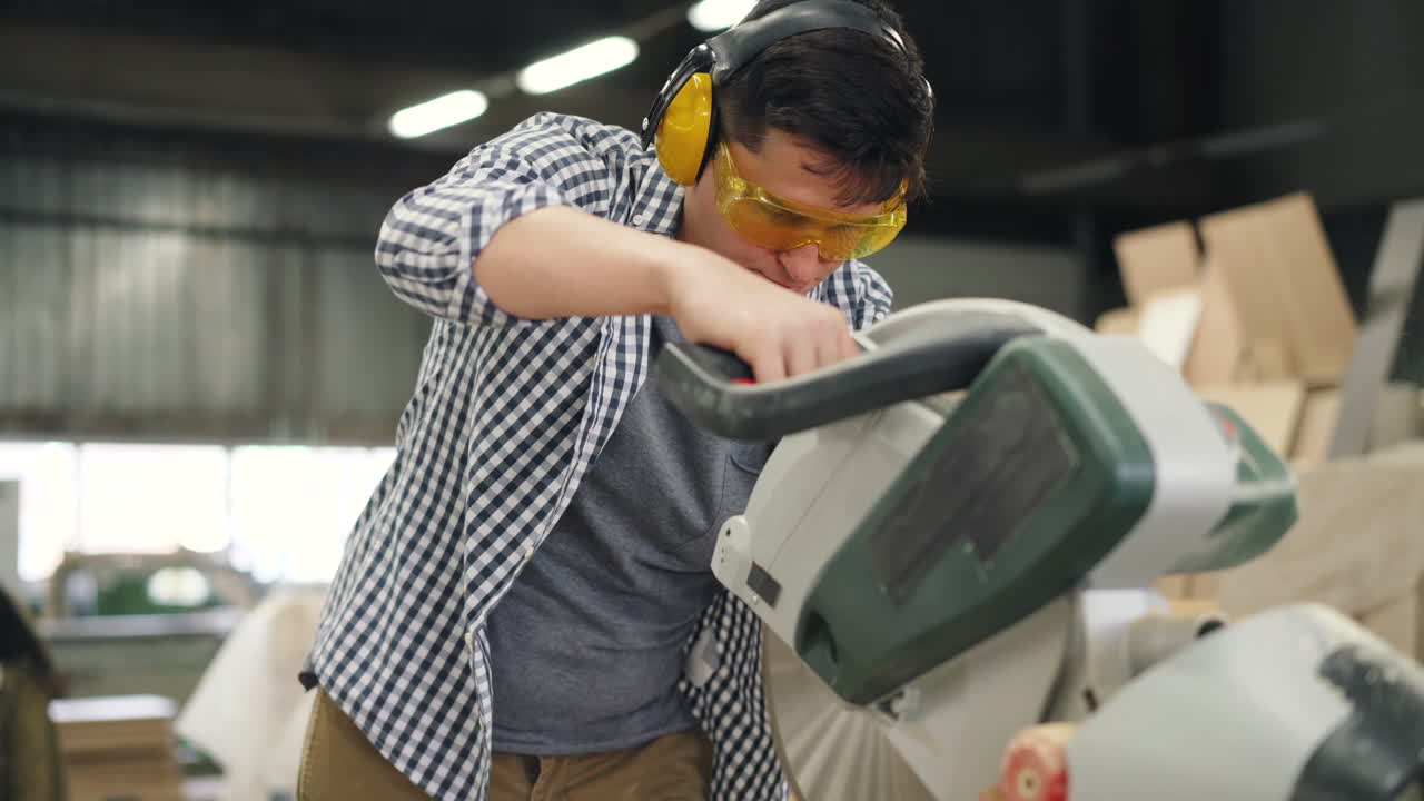 Carpenter using a circular saw in a workshop