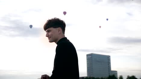 happy young, positive man dancing and smiling on the bridge