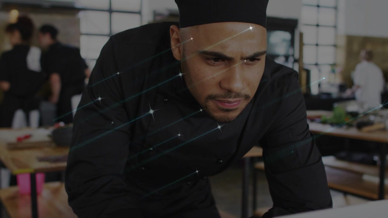 Kitchen chef leaning over laptop after order alert, animated streaks highlighting orders on laptop