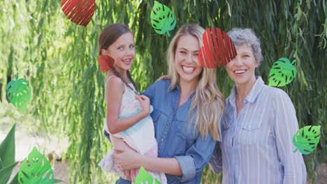 Animation-of-hearts-and-leaves-over-smiling-caucasian-multigeneration-women-in-garden