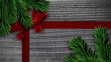 Animation-of-christmas-red-present-ribbon-with-snow-falling-on-grey