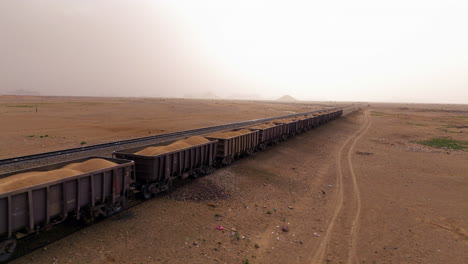 train carrying sand in the desert near the pyramids