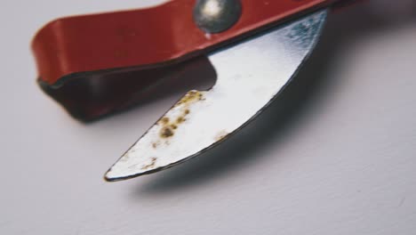 vintage-can-opener-with-red-handle-lies-on-white-background