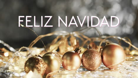 feliz navidad text in white over gold christmas baubles and lights