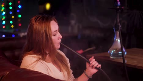 woman smoking hookah in a nightclub