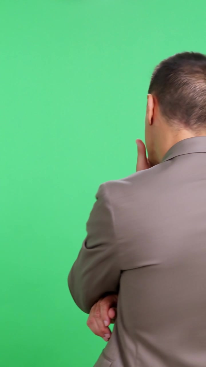 Rear view of businessman stretching his neck and back