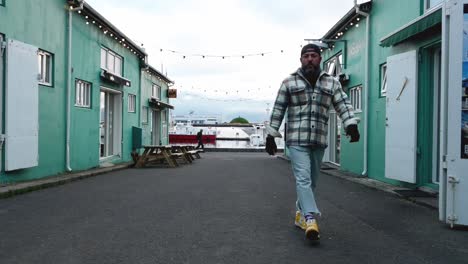 man walking through the streets of the port of reykjavik