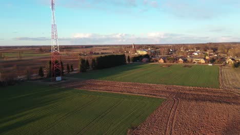 aerial view antenna tower in the countryside fields near the town